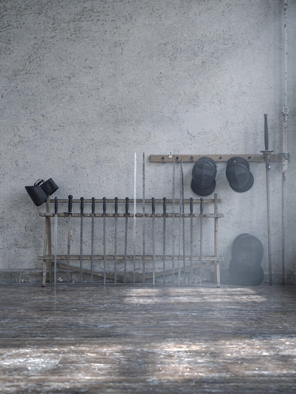A wooden rack of steel training longswords with fencing masks hanging beside it